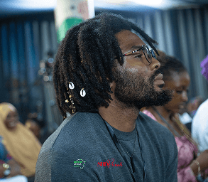Founder listening attentively during startup keynote Lagos